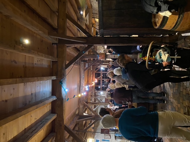 Person using a pen to cross a task off a productivity paper card.